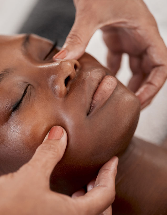 close up of a young woman receiving a facial massage